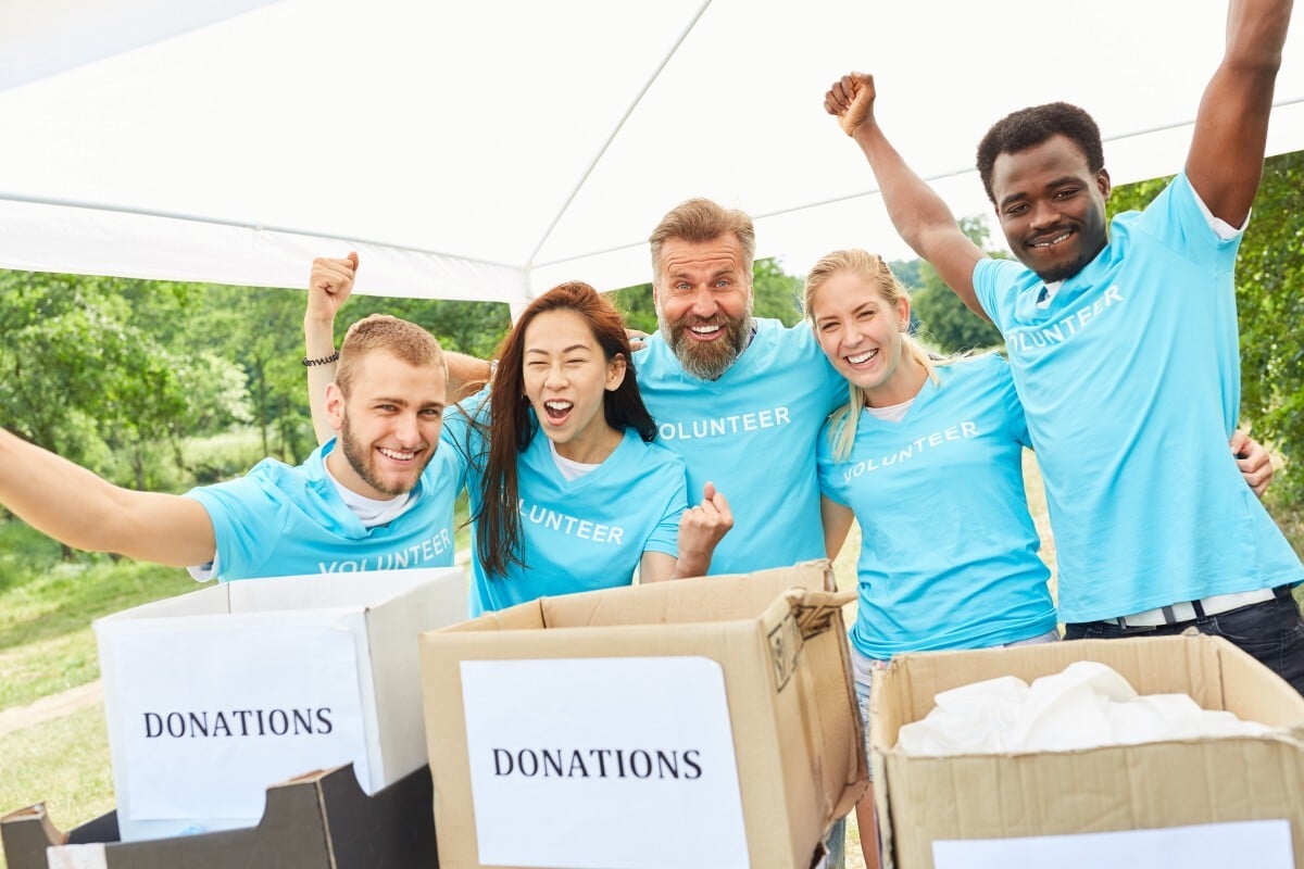 Fundraising team celebrating in blue t-shirts