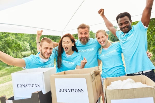 Fundraising team celebrating in blue t-shirts