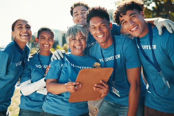 Happy volunteer team smiling together